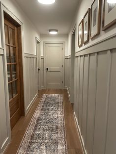 the hallway is clean and ready for guests to use it as an entrance way in this home