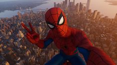 the spider - man is standing in front of a cityscape with his hands up