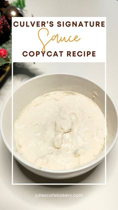 a white bowl filled with cream sauce on top of a table next to christmas decorations