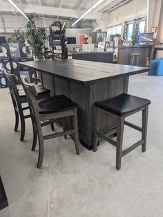 a large table and chairs in a room with lots of furniture on the floor around it