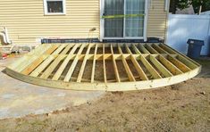 a wooden deck being built in front of a house