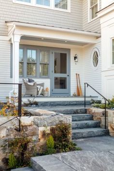 a house with stone steps leading up to the front door