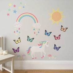 a child's room with a unicorn and rainbow wall decals