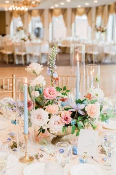 a table topped with lots of flowers and candles