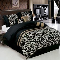 a bed with black and gold comforters in a room