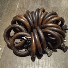 a bunch of metal rings sitting on top of a wooden floor