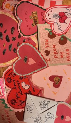 valentine's day cards and envelopes laid out on a table