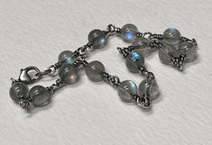 "Each labradorite bead was hand selected for its placement of labradorescense (that beautiful billowy electric blue, green, or gold that appears to dance around the gem). All metal used is solid sterling silver that has been oxidized.   The beads are 5mm smooth round. The bracelet measures 7 1/2\" " Artisan Silver Labradorite Bracelet, Silver Labradorite Gemstone Bead Bracelets, Silver Labradorite Bracelet With Gemstone Beads, Silver Labradorite Bracelets With Gemstone Beads, Silver Labradorite Bracelets With Round Beads, Silver Labradorite Bracelets, Handmade Silver Labradorite Beaded Bracelets, Beads Craft Jewelry, Beads Craft