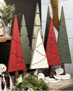 three wooden christmas trees sitting on top of a table