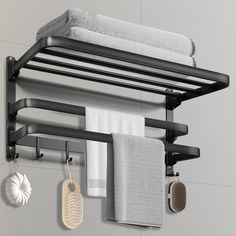 the towel rack is hanging on the wall next to towels and other bathroom accessories,