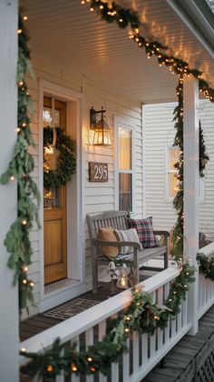 a porch decorated for christmas with garland and lights