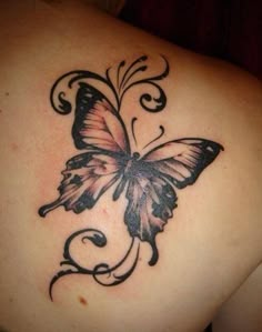 a butterfly tattoo on the back of a woman's shoulder