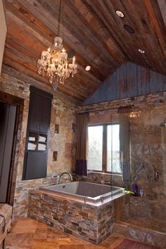 the bathroom is decorated in rustic style with stone walls and wood ceilings, along with a chandelier