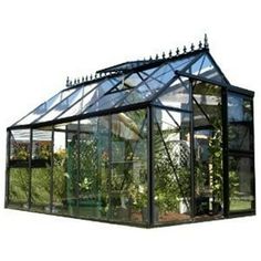 a green house with glass walls and plants in the front ground level, on a white background