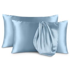 two blue pillows and one pillow with a satin bow on the front, both in light blue