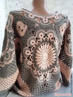 a crocheted sweater is sitting on a mannequin