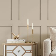 a living room scene with focus on the end table and side tables that have candles on them