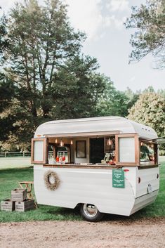 an old camper is parked in the grass