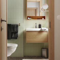 a bathroom with a sink, mirror and toilet