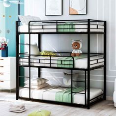 a black metal bunk bed in a child's room with green and white decor