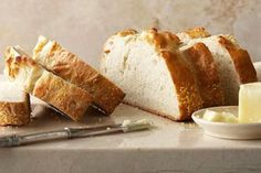 sliced loaf of bread sitting on top of a counter next to butter