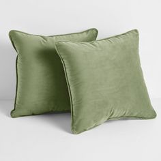 two green pillows sitting next to each other