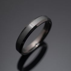 a wedding ring is shown against a gray background