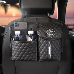 the interior of a car with two bottles and an ipod holder in front of it