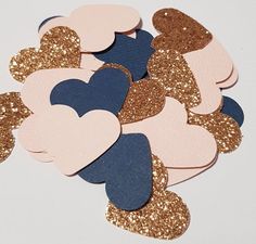 heart shaped confetti cutouts in pink, blue and gold