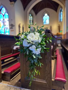 a bouquet of flowers sitting on top of a pew