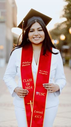 a woman wearing a red and yellow graduation stole