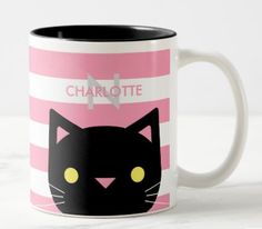 a black cat with yellow eyes on a pink and white striped coffee mug that says charlotte