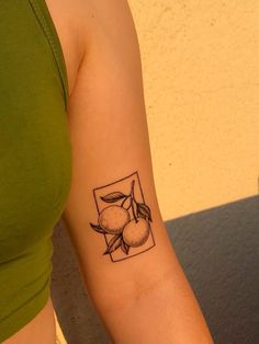 a woman with a tattoo on her arm that has peaches and leaves in it