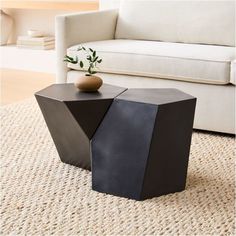 a black table sitting on top of a rug next to a couch