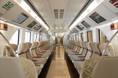 an empty train car with many seats on it