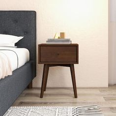 a bed with a night stand next to it