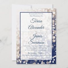 a wedding card with blue and silver glitters on the front, featuring an elegant design