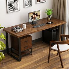 a desk with a computer, chair and pictures on the wall