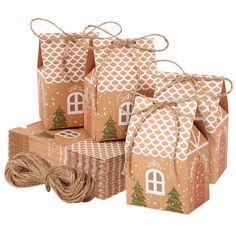 brown paper bags with houses on them and twine wrapped around the edges, tied together