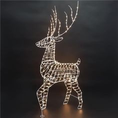 a lighted deer standing in the dark