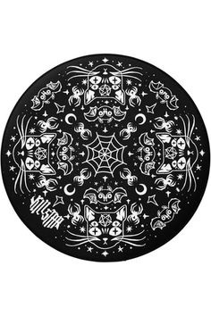 a black plate with white designs and stars in the center, on a white background