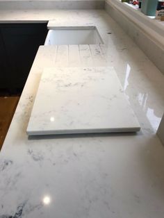 a white counter top sitting next to a window