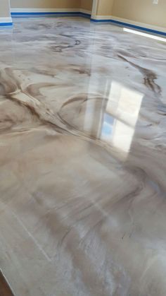 an empty room with some paint on the floor