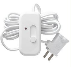 an electronic device plugged in to a wall charger with a white cord and two sockets