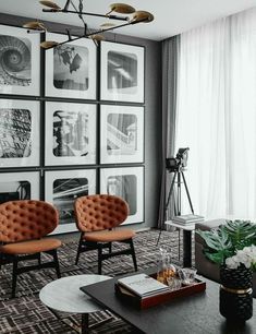 a living room filled with furniture and pictures on the wall