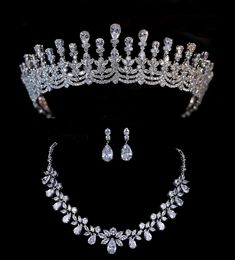 CZ Tiara Crown and Jewelry Set This stunning cz tiara and coordinating jewelry set will be the perfect accessory set for your wedding or quinceanera. Tiara: This silver plated tiara crown will add a regal touch to your special day. The perfect complement to your wedding or quinceanera gown, it features a delicate scallop edge, sparkling floral cz designs and a multi-peak top with brilliant teardrop cz crystals. This ear to ear bling headpiece will provide sparkle from every angle. Jewelry Set: C Bridgerton Outfits, Quince Crown, Camp Themes, Vintage Wedding Accessories, Quinceanera Jewelry, Quinceanera Tiaras, Quinceañera Ideas, Crystal Wedding Tiaras, Tiara Crown