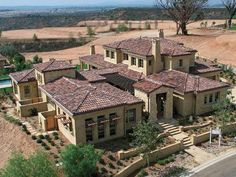 an aerial view of a large home in the middle of a rural area with trees and bushes