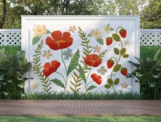 a white fence with flowers and leaves painted on it