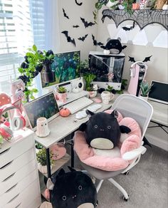 two stuffed animals sitting on top of a chair in front of a desk filled with plants