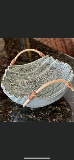 a blue basket sitting on top of a counter next to a wooden stick in it